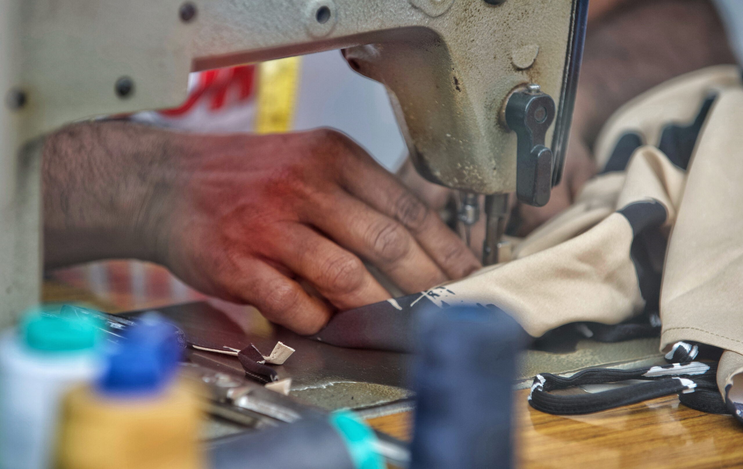 an-unrecognizable-tailor-uses-an-old-sewing-machin-2023-11-27-05-20-13-utc