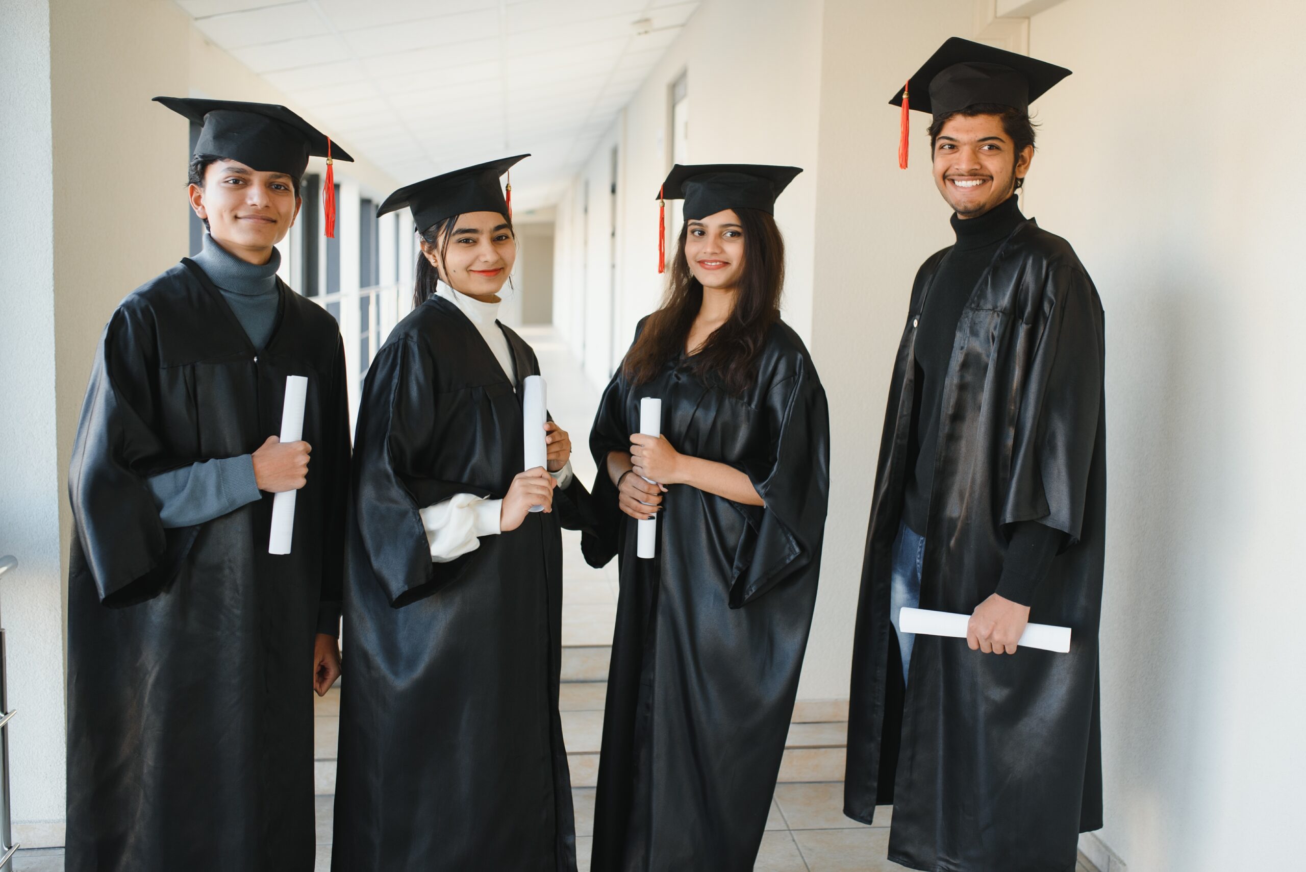 education, graduation and people concept - group of happy indian students